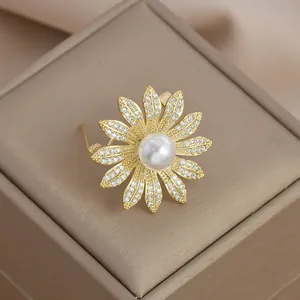 Close-up of daisy brooch with micro-pave zircons and a large pearl on a jewelry box