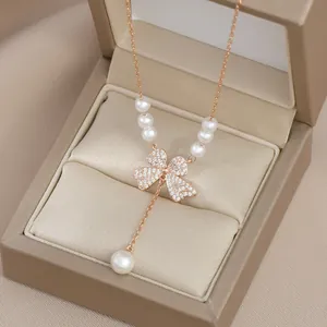 Elegant rose gold necklace with bow pendant, encrusted diamonds and drop pearl charms