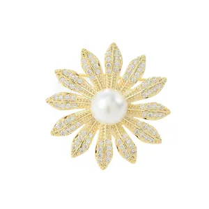 Exquisite gold daisy brooch with micro-pave cubic zirconia petals and a large center pearl