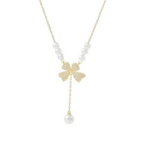 Elegant gold plated clover necklace with pave diamonds and hanging pearl tassels