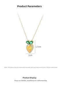 Detail showing a carrot pendant with yellow and green zircons on a gold chain