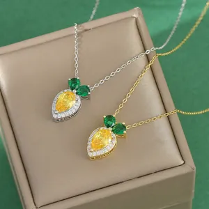 Elegant carrot pendant necklace with yellow zircon on a luxury display jewelry box