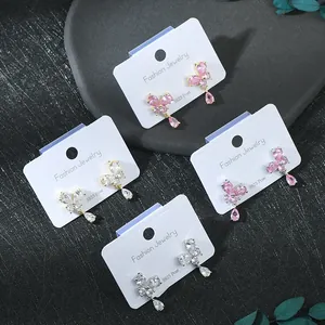 Detail of silver S925 needle butterfly earrings with pink and clear zircon water drops