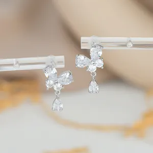 Macro detail of silver butterfly earrings with sparkling cubic zirconia teardrop pendant