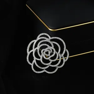 Macro shot of camellia brooch with dense white cubic zirconia and hollow alloy layers