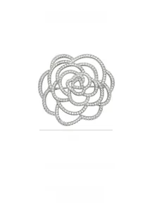 Detailed close-up showing the 4.1cm silver camellia brooch with white zircon inlay