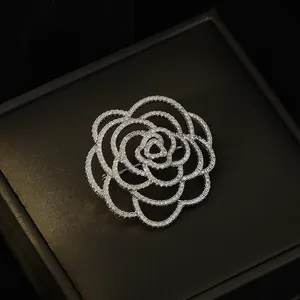 Exquisite silver-toned camellia flower brooch paved with shimmering crystals on black box