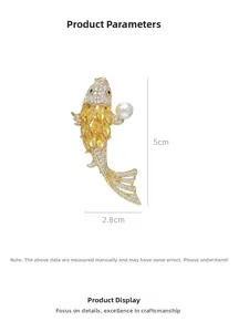 Detailed view of gold koi fish brooch with white pearls and sparkling cubic zirconia