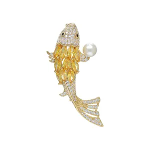Elegant gold koi fish brooch with yellow crystals, white zircons and a pearl detail
