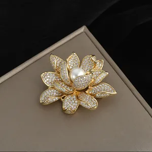 Détail d'une broche lotus de luxe avec des zircons scintillants et une perle blanche centrale