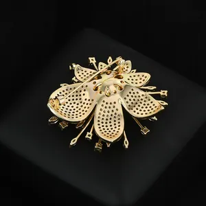 Detailed back view of golden flower brooch showing the pin clasp and intricate metalwork