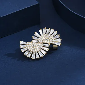 Detailed macro view of gold-plated dress brooch featuring radial zircon stones
