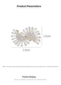 Detailed view of a gold-finish double fan brooch with crystals and 2.4cm by 1.6cm dimensions