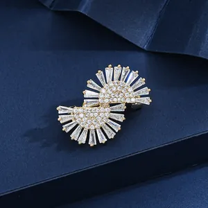 Elegant gold S-shaped brooch with sunburst zircon inlay for formal dress accents