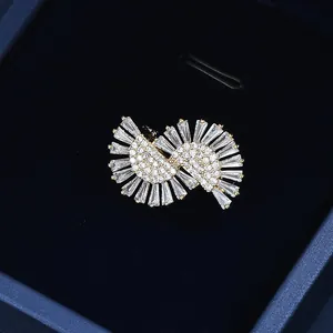 Detailed close-up of a French style pearl brooch with gold base and zircon crystals