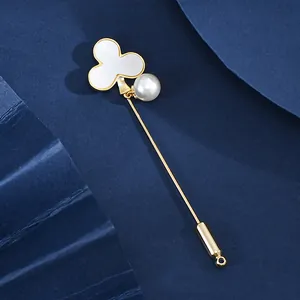 Elegant gold-plated clover brooch with natural shell and white pearl on a long pin