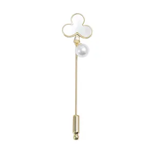 Elegant gold clover brooch with natural shell inlay and white pearl on a long pin