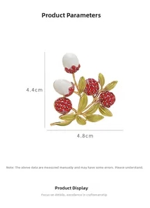 Detailed view of lychee brooch with dimensions 4.4cm by 4.8cm and red rhinestones