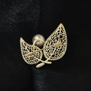 Gold leaf brooch with white pearl and hollow design shown from the back perspective
