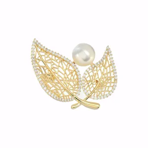 Gold plated brooch with hollow leaves, sparkling cubic zirconia and a large pearl