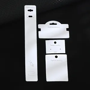 Detail view of four white jewelry display cards for earrings, necklaces and bracelets
