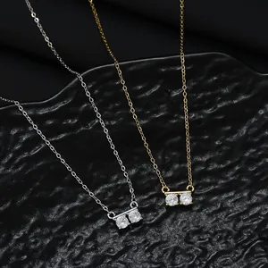 Minimalist gold and silver necklaces with double zircon pendants on black background