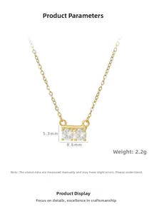 Detailed view of gold necklace pendant with dimensions 8.6mm x 5.3mm and two zircon stones