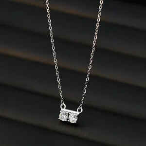 Elegant silver-toned necklace with two round-cut zircon pendants on a sleek cable chain