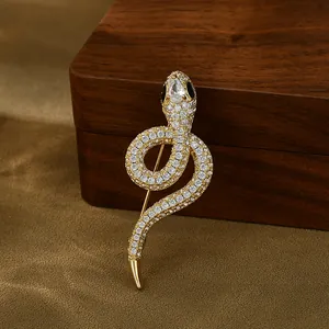 Luxurious gold-plated snake brooch with sparkling cubic zirconia and elegant curves