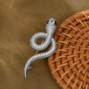 Macro detail of silver snake brooch featuring cubic zirconia pave and drop-shaped main stone