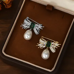 Elegant bow brooches with emerald zircon and pearl drop in gold and silver finish