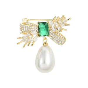 Elegant gold wheat brooch with emerald zircon, crystals, and a hanging pearl drop charm