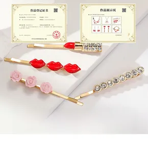 Detail of four hair clips featuring red lips, pink roses, and shiny rhinestones in gold