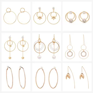 Detail view of nine pairs of assorted gold-tone earrings with pearls and crystals