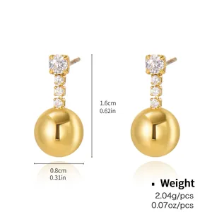 Macro detail of gold earrings featuring four white cubic zirconia stones and metal bead