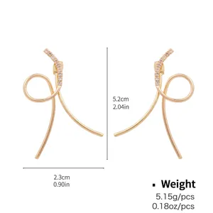Elegant gold-tone hoop earrings with crisscross curved lines and sparkling cubic zirconia