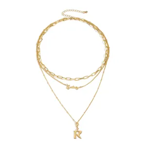 Three-layer gold necklace set with paperclip chain, Sydney text, and letter R pendant