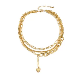 Chic multi-layer gold necklace featuring paperclip chain and polished heart pendant