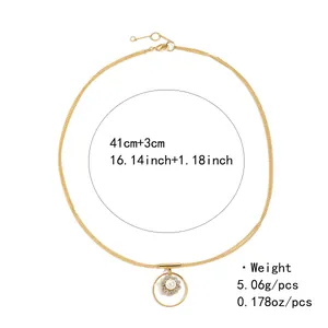 Détail du collier en laiton plaqué or avec pendentif fleur en zircon et perle