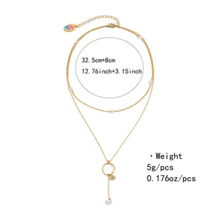 Detail view of double-layer gold necklace with pearls, heart pendant and size specs