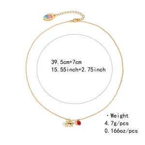Detailed view of golden necklace with pig and red gem charms, featuring length measurements