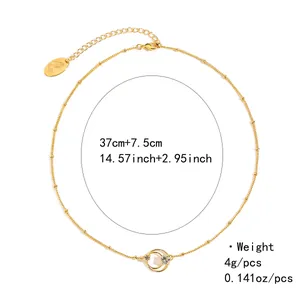 Detail view of gold satellite chain necklace with circular charms and 7.5cm extender