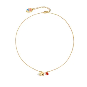 Golden necklace with cute pig pendant and red crystal bead on a minimalist white background