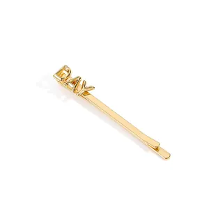 Elegant gold-plated hair clip featuring a 3D DAY letter design on a white background