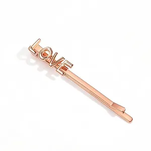Close-up of rose gold Love letter hair clip with polished metallic finish for women