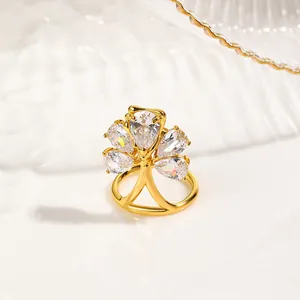 Macro view of gold-plated copper nail ring featuring five pear-cut zircon stones