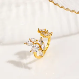 Detail of gold plated nail ring with marquise cut zircon stones in floral design