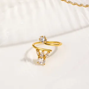Detail of gold-plated nail ring featuring a sparkling star charm and crown with zircons