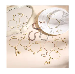 Detailed close-up of adjustable heart and star charm bracelets in gold and silver finishes
