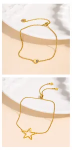 Detail of adjustable gold bracelets featuring heart and star charms with pull-string clasp